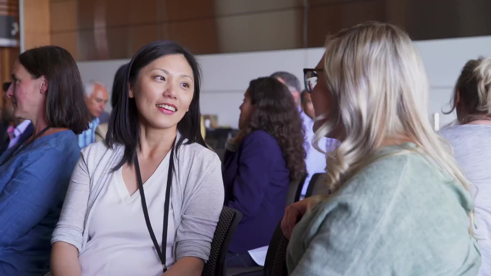 Two colleagues talking at a conference